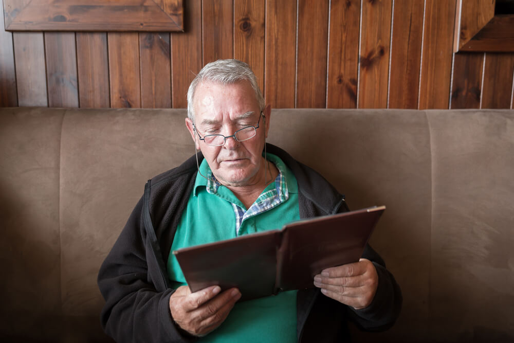 man reading pre-op guide for mohs surgery near Johns Creek